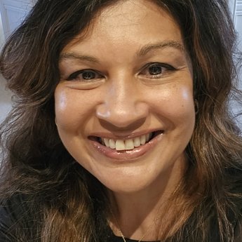 A head and shoulders portrait of a woman, Dr Rosamina Ahmad, an interventional radiologist